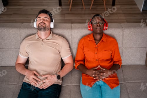 Preview: Relaxing couple listens to music together on a cozy couch in a modern living room