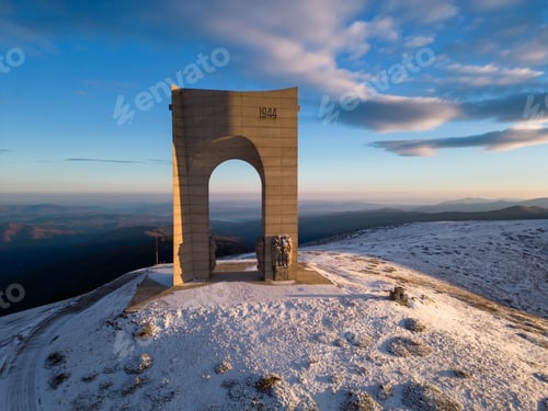 Preview: Beautiful aerial view of snow covered mountains and the Monument Arch of Liberty at the main ridge
