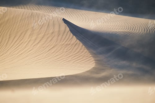 Preview: The sand dunes during sunset and strong wind. Summer landscape in the desert.