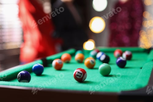 Preview: People near green billiard table with many colorful balls indoors, selective focus