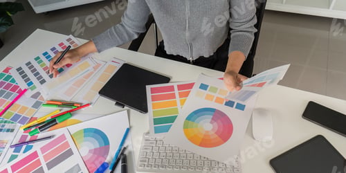 Preview: Creative Graphic Designer Working on Color Palettes and Design Concepts at Modern Workspace