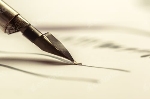 Preview: Close up of a fountain pen writing words on paper in a simple workspace setting