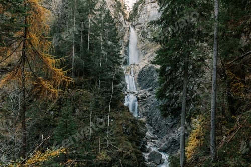 Preview: Beautiful waterfall in moody forest in autumn