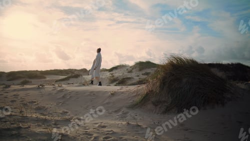 Preview: Lonely woman walking sand dunes. Dreamy tourist enjoying weekend trip outdoors.