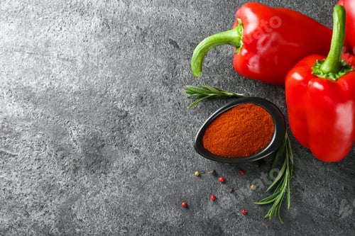 Preview: Dish of paprika with ingredients on grey table, flat lay. Space for text