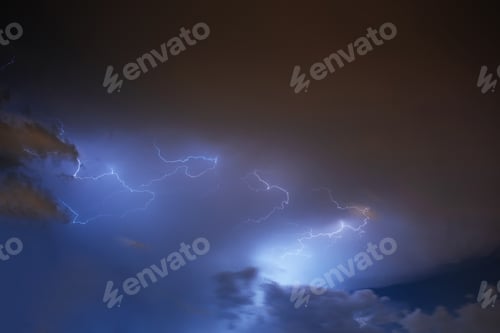 Preview: Lightning strike on the cloudy dark sky. Fantastic summer night
