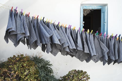 Preview: Beautiful shot of gray rags hanged outside a house in Mykonos, Greece