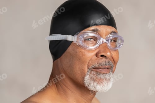 Preview: Senior African American swimmer wearing a swim cap and goggles