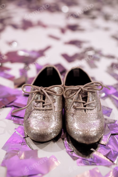 Vista previa: Baby stylish shoes on white background with colorful confetti an copyspace. place for inscription.