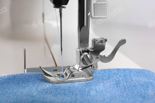 Preview: Sewing machine with light blue cloth, closeup
