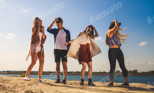 Preview: Group of friends partying and dancing at the beach