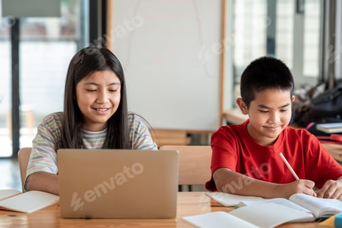 Preview: Front view of Asian brothers and sisters, studying online together at home