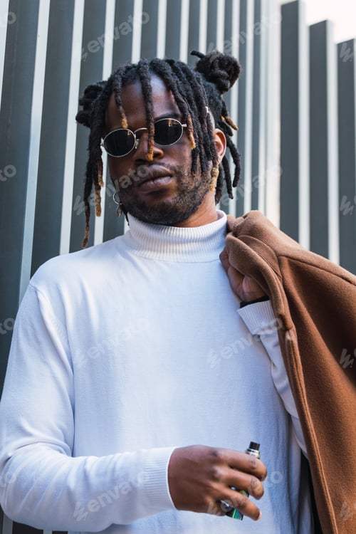 Preview: Hipster black man with electronic cigarette on the street