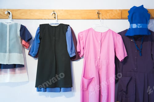 Preview: Colorful Dresses and Bonnet Hanging on Wall