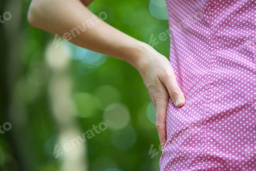 Preview: Close up of woman hand on her waist.