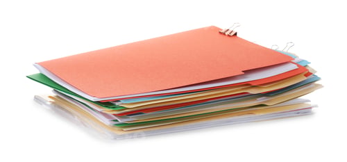 Preview: Stack of colorful folders with documents and binder clips isolated on white