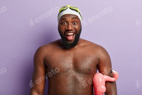 Preview: Headshot of happy African American man spends leisure time in resort place, has nice impressions aft
