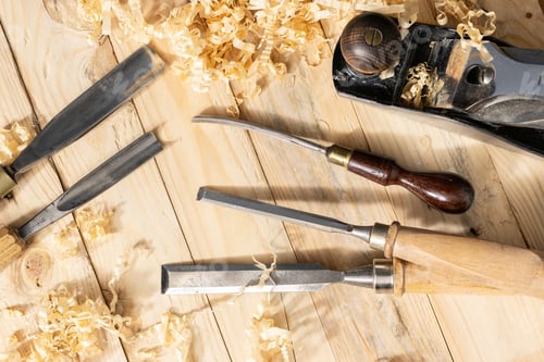 Preview: Traditional carpenter tools and wood shavings lying on wooden background