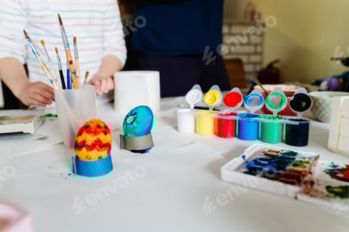 Preview: Happy Easter! Painting eggs. Happy family painting eggs for Easter celebration.
