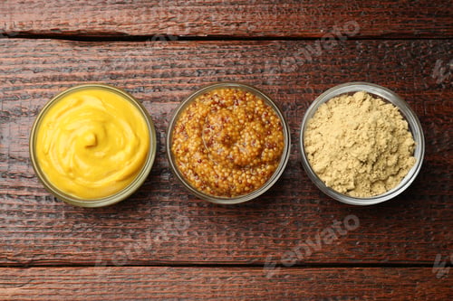 Preview: Different types of mustard on wooden table, flat lay