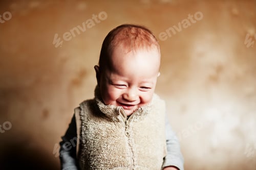 Preview: Joyful baby chuckling in a cozy vest