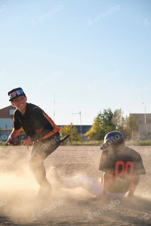 Preview: Baseball players sliding into base during game