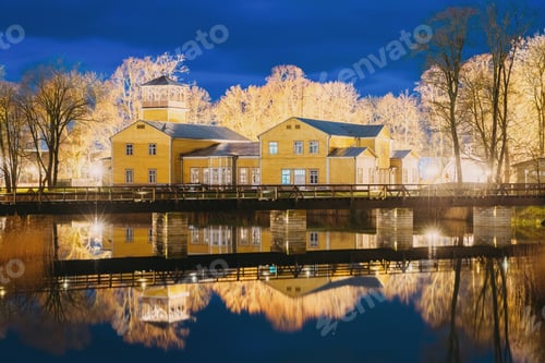 Preview: Kuressaare, Estonia. Old Traditional Yellow Wooden House In Evening Blue Hour Night