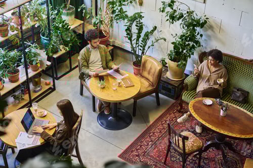 Preview: Group of young intercultural analysts or brokers working in cafe