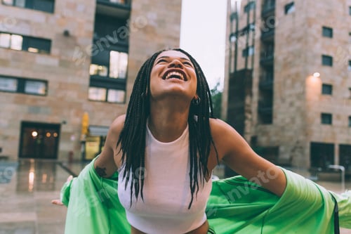 Preview: Woman welcoming rain in town square, Milan, Italy