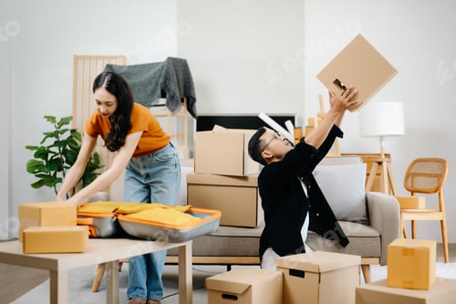 Preview: young asian man and woman helping to lift boxes on sofa for the new home,