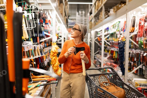Preview: Woman shopping for tools in a hardware store, exploring options for DIY projects during the day