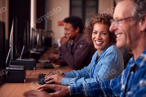 Preview: Group Of Mature Adult Students In Class Working At Computers In College Library