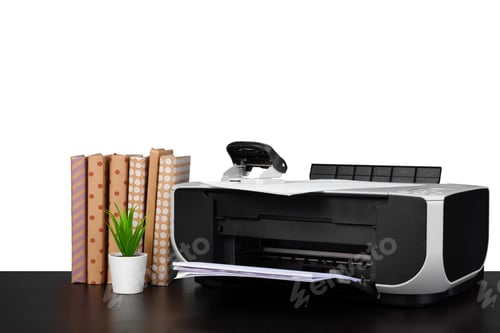 Preview: Printer and stack of books on black table against white background