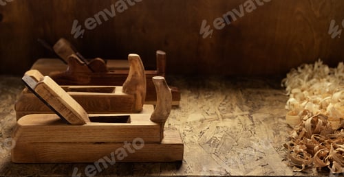 Preview: Plane jointer carpenter or joiner tool and wooden shavings. Woodworking tools on wooden table