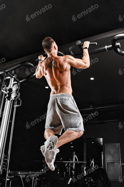 Preview: Bodybuilder does pull-ups. Muscular man in the gym. Preparation for competitions, functional