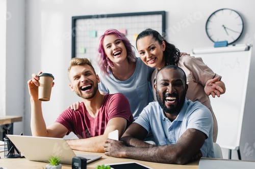 Preview: Selective focus of multiethnic business people looking at camera while working together in office