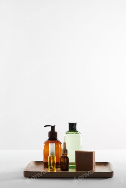 Preview: Wooden tray with various cosmetic containers and soap on white surface