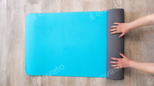 Preview: Top view of young woman with exercise mat preparing for yoga sports training