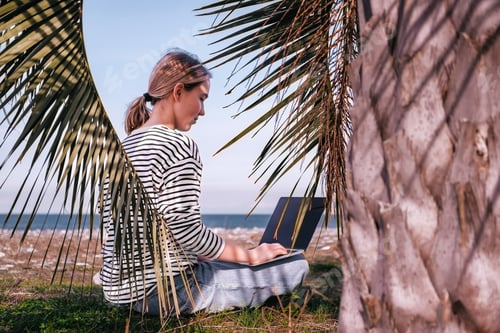 Preview: Remote work.Girl freelancer works remotely sea shore. workation, remote work,leisure, work life bala