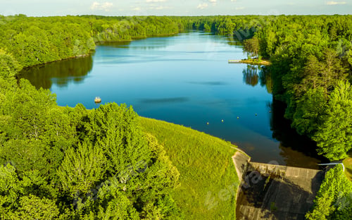 Preview: Beautiful view of Lake Michael surrounded by lush green trees in the foreground. North Carolina.