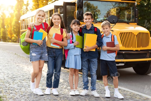 Preview: Diverse group of kids standing outside by yellow school bus,