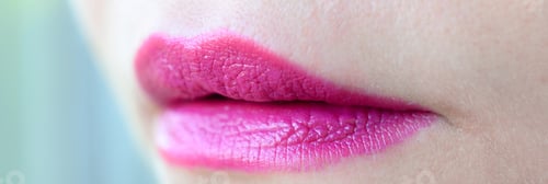 Preview: Close up shot of woman lips with glossy fuchsia lipstick