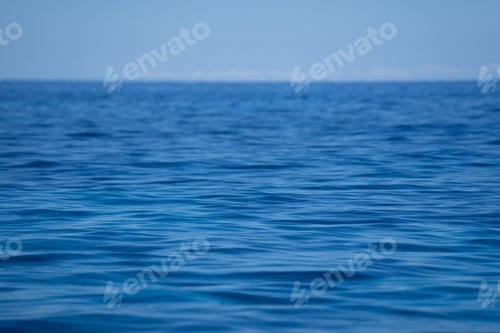 Preview: Waves of the ocean under a clear blue sky