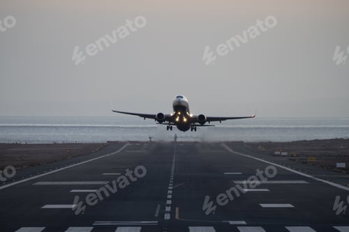 Preview: Airplane taking off from runway at dusk