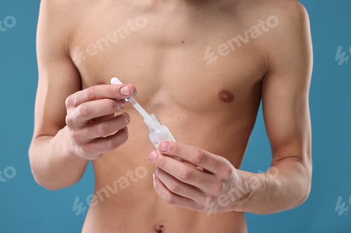 Preview: Man with serum on blue background, closeup