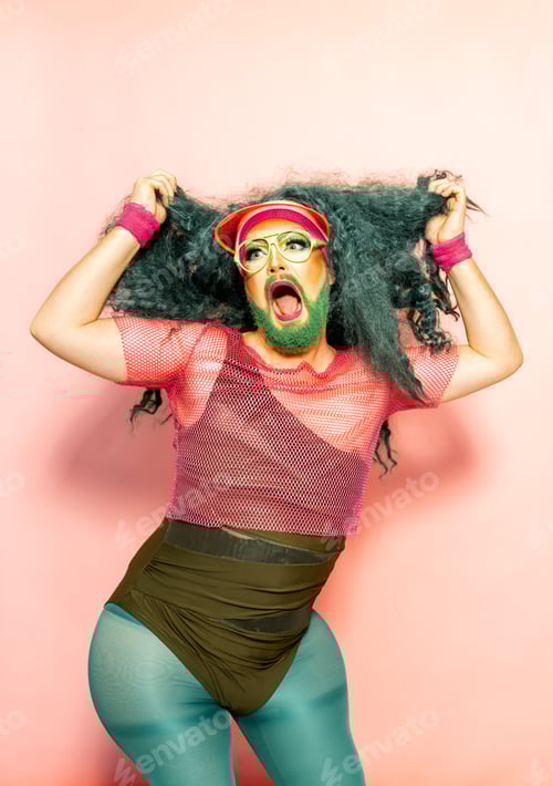 Preview: Expressive androgynous male in casual clothes touching hair