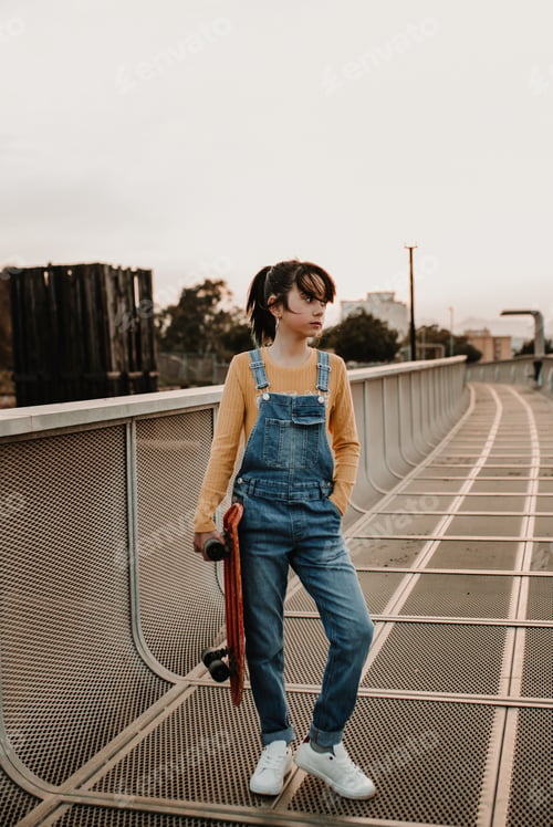 Preview: Girl with skateboard on walkway