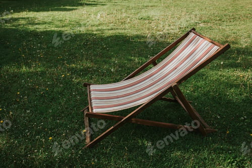 Lawn chair sits on verdant grass