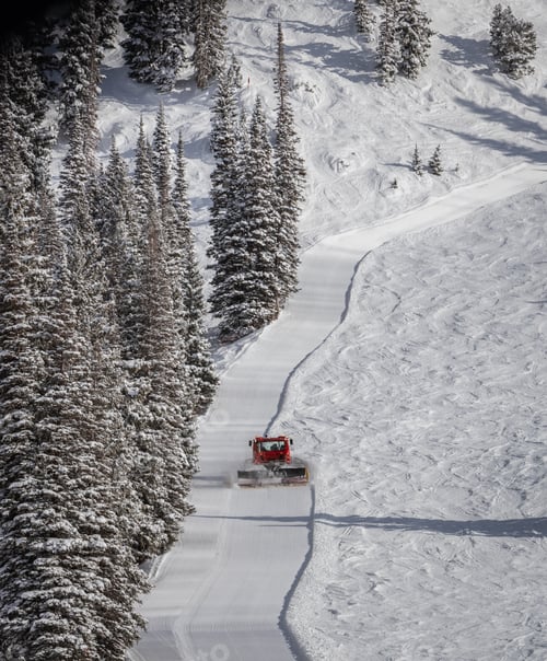 Preview: Aerial view of a snow cat grooms a ski trail at the end of the day at Alta Utah