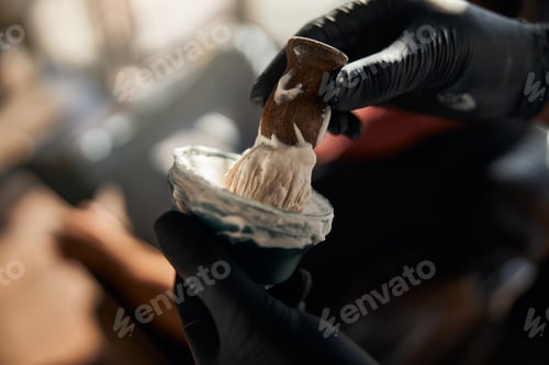 Preview: Male barber hands lathering shaving cream with brush